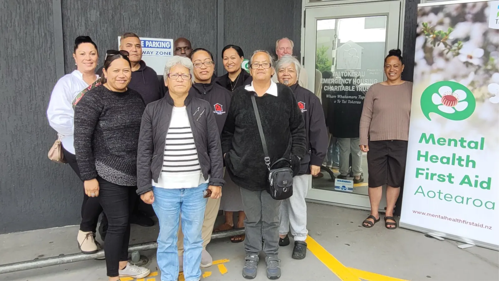 A community and whānau group outside Tai Tokerau Emergency Housing after Mental Health First Aid training