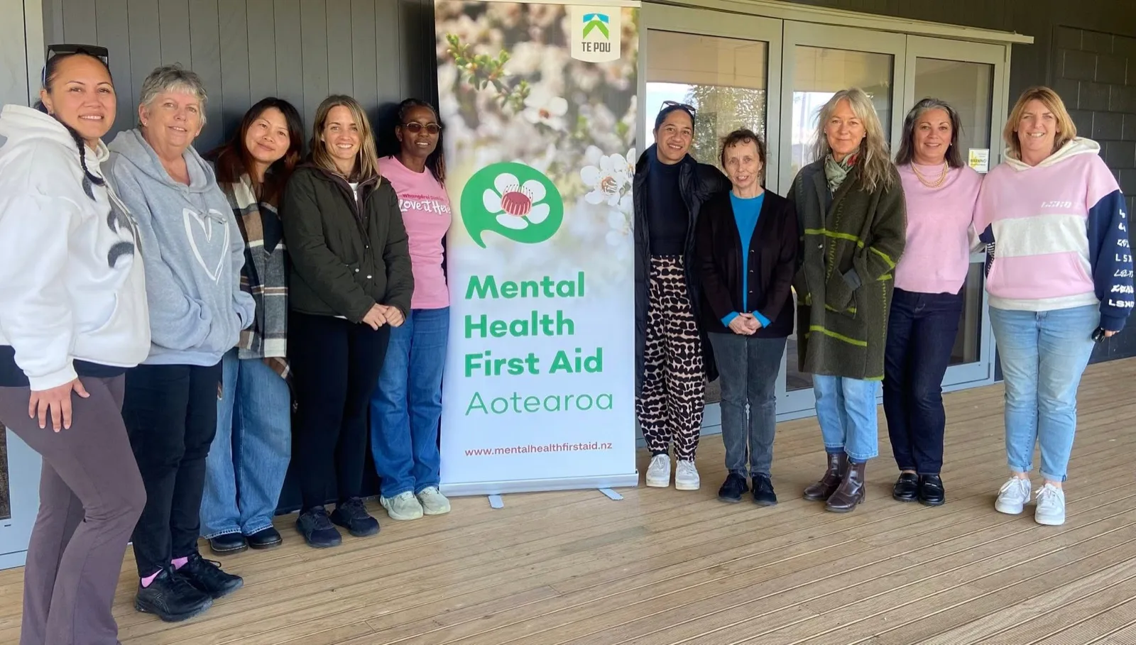 A Mental Health First Aid workshop group with their certificates