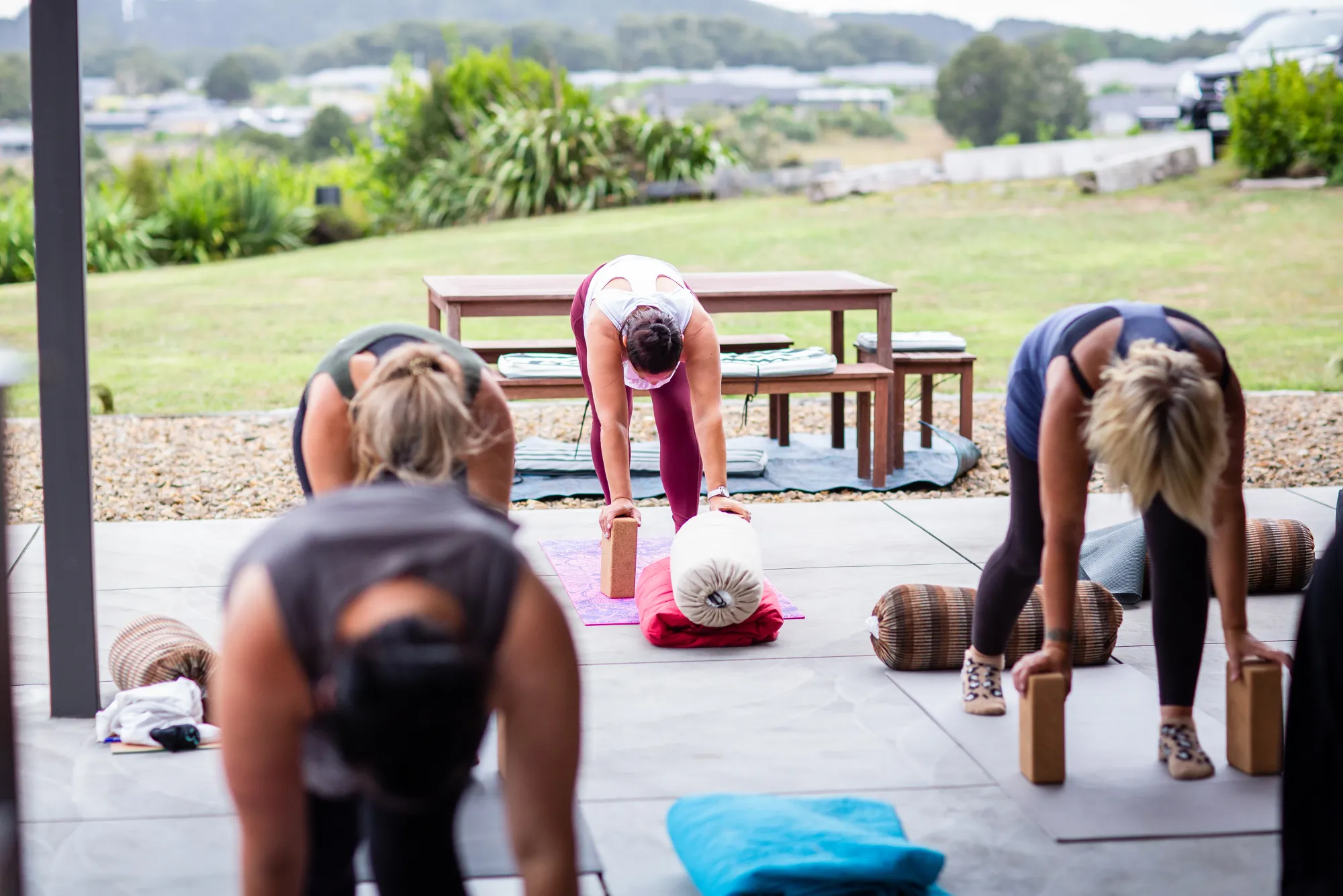 Retreat participants in a gentle standing stretch outdoors