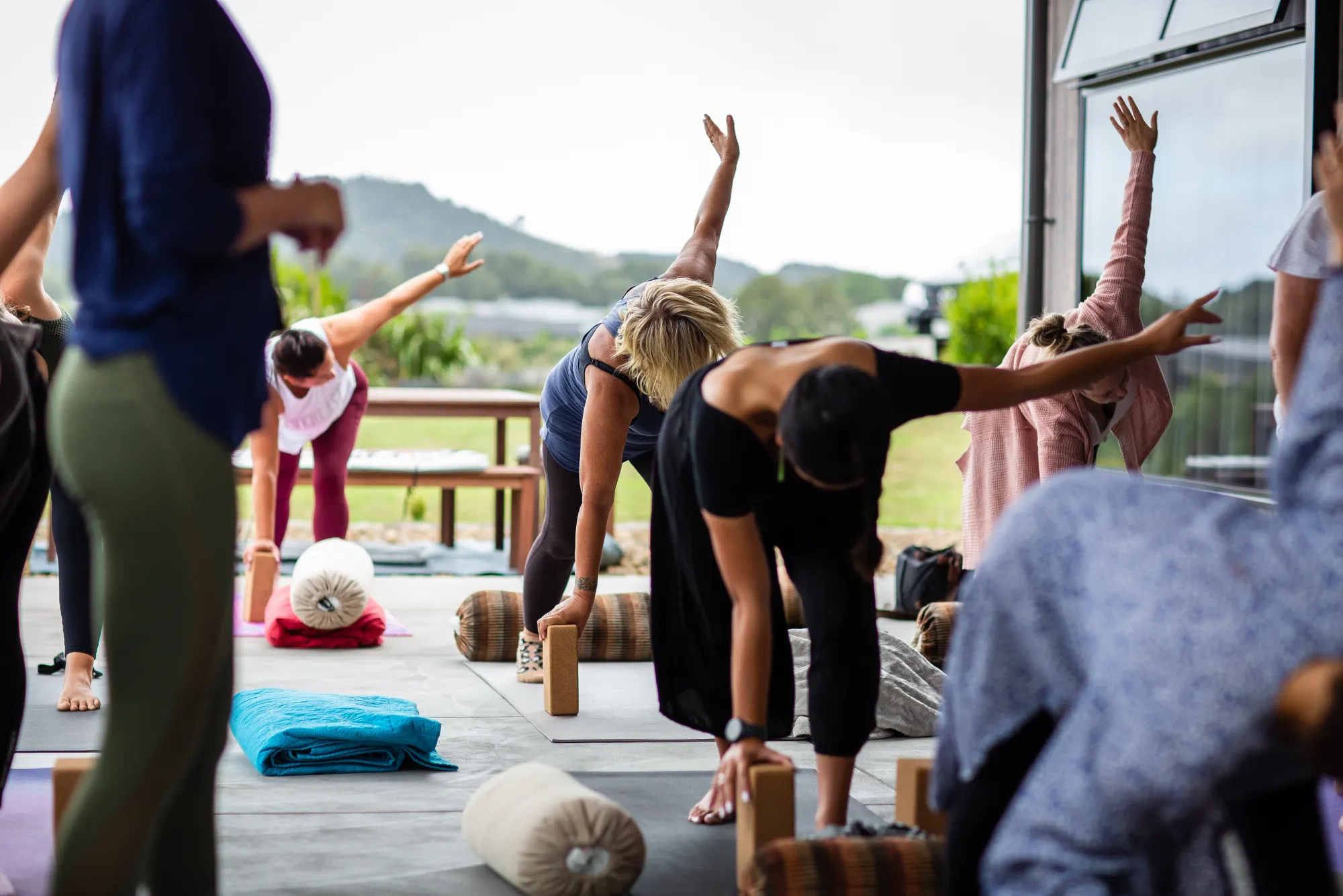 A retreat participant stretching outdoors in a natural setting