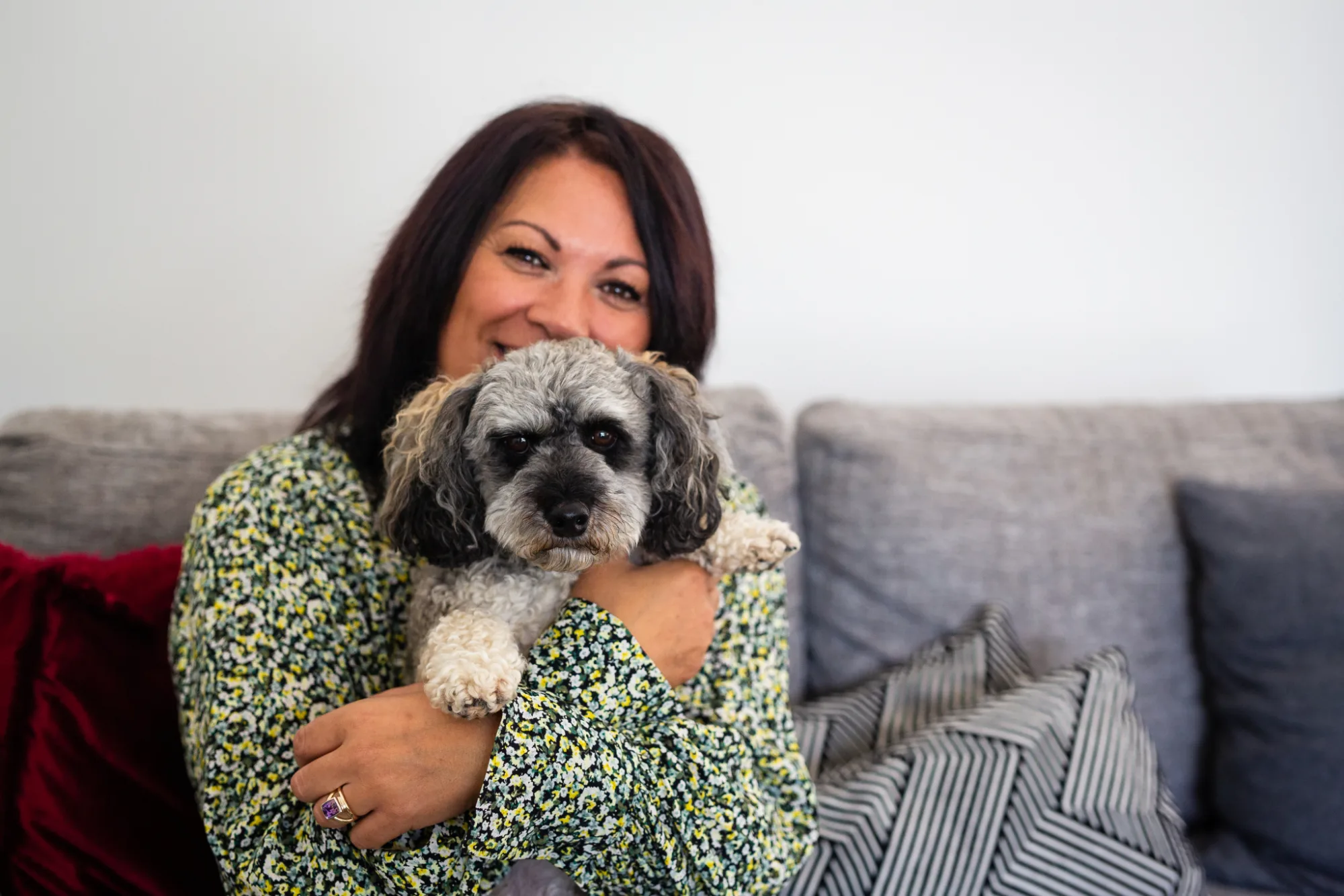 Sharon Gibson, Te Pou-accredited Mental Health First Aid facilitator and founder of Pathways to Wellbeing, smiling with her dog Buddy