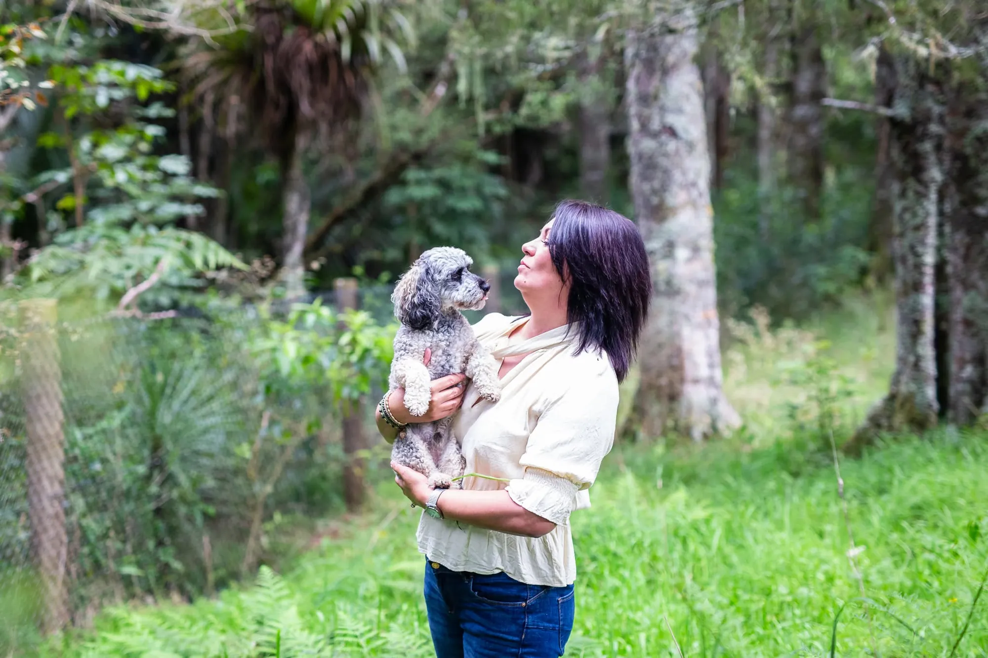 Sharon Gibson standing with her dog in native bush