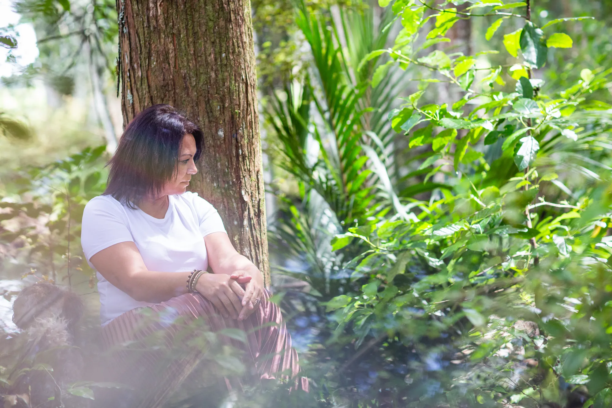 Sharon Gibson seated in a forest clearing